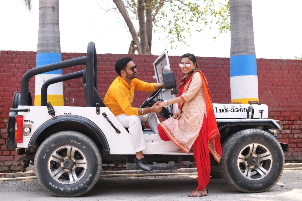 Couple in a decorated open vehicle during a celebration-style shoot